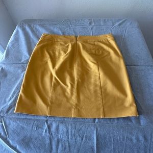 Ann Taylor Gold mini skirt with pockets,  zipper and hocks in the back